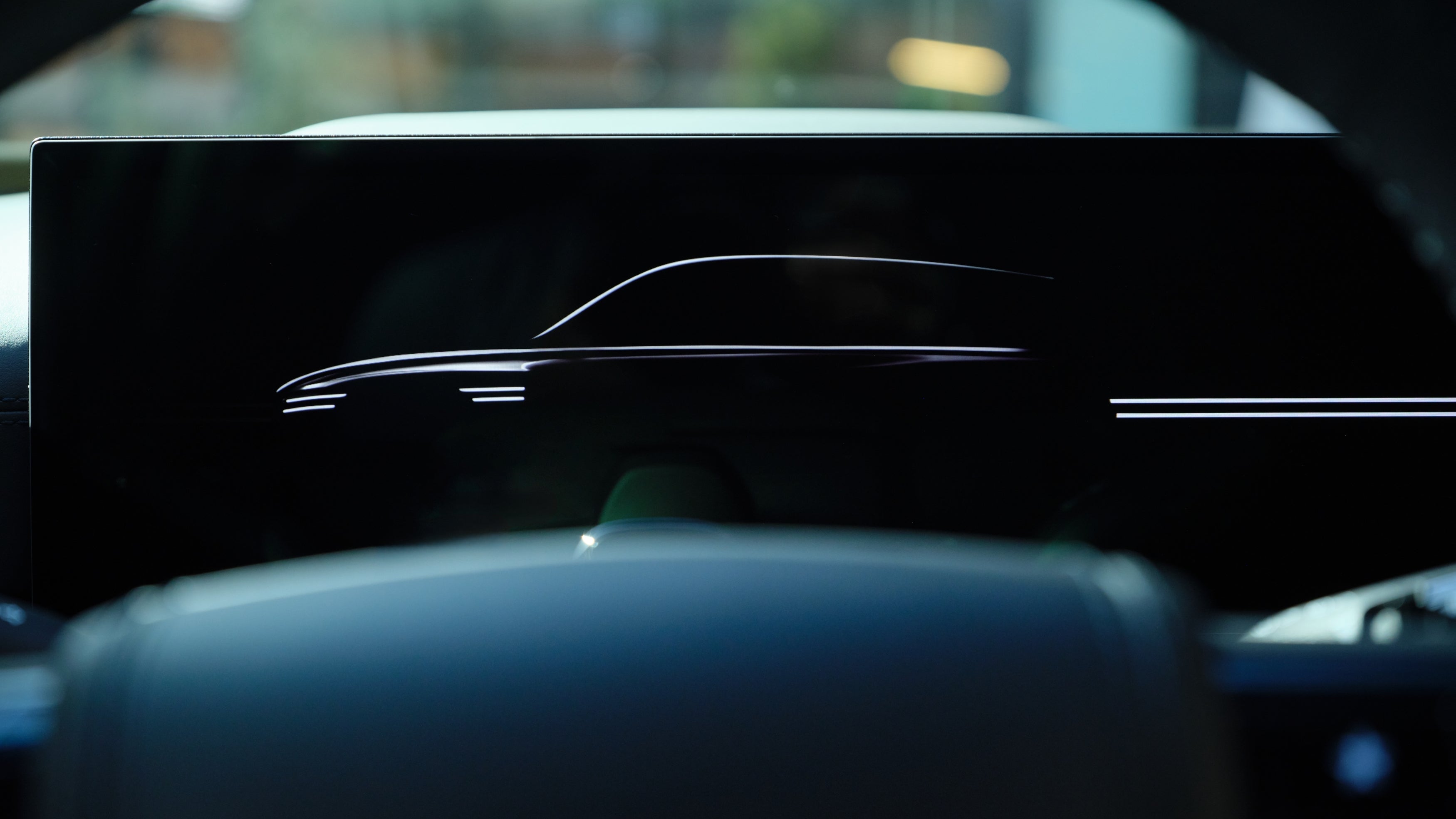 A closeup shot of the large touchscreen of the 2026 Genesis GV80 in Chandler, displaying a side view of the new Genesis SUV.